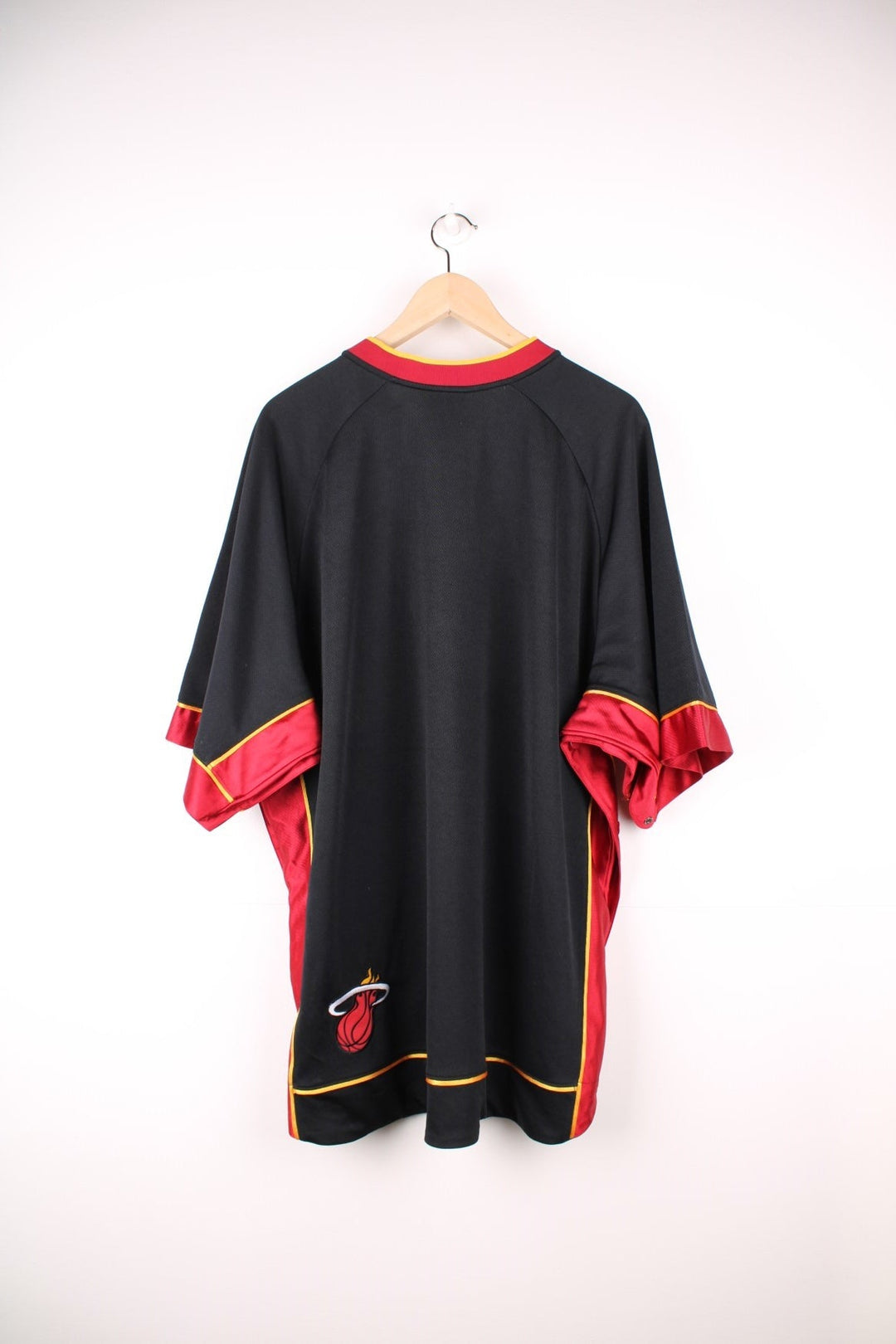 NBA Miami Heat Nike Training Jersey in a black and red colourway, popper buttons going down the side and under arms, v neck, and has the logos embroidered on the front. 