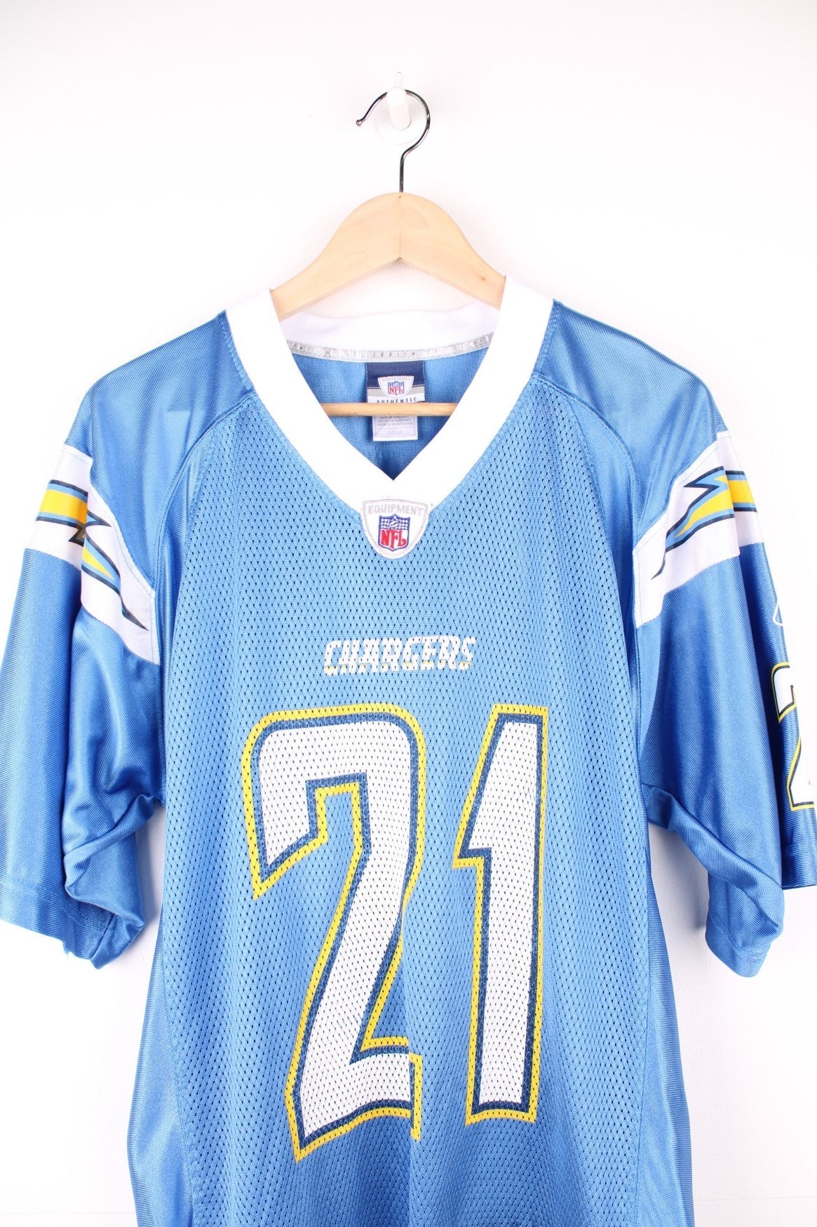 San Diego Chargers NFL Jersey in the blue, white and yellow team colourway, LaDainian Tomlinson number 21 printed on the back, and the logos on the front. 