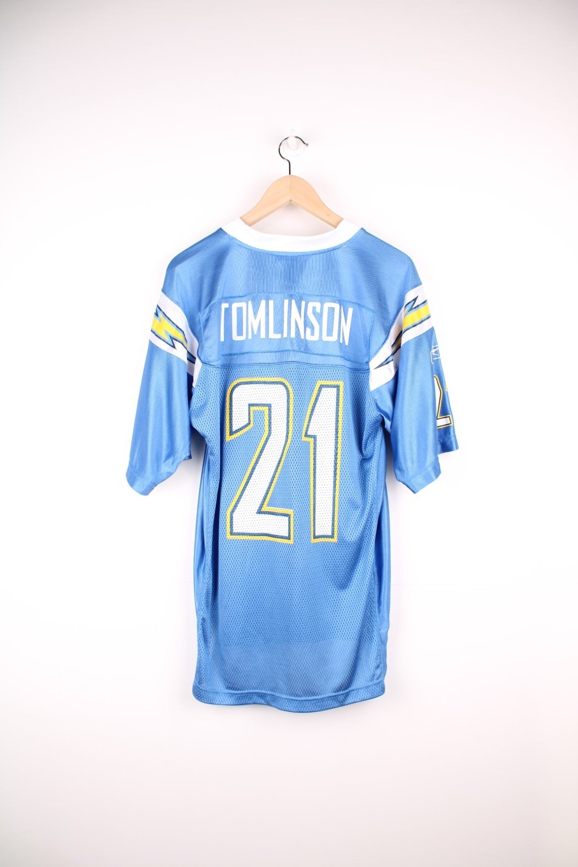 San Diego Chargers NFL Jersey in the blue, white and yellow team colourway, LaDainian Tomlinson number 21 printed on the back, and the logos on the front. 