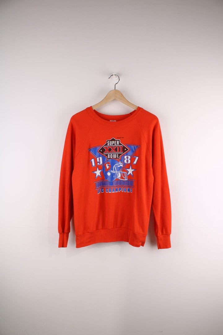 Vintage Denver Broncos 1987 Super Bowl sweatshirt in orange with blue and white logo graphic on the front.