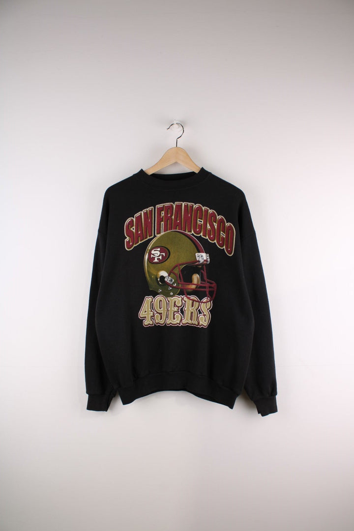 Vintage San Francisco 49ers in black with football helmet graphic and red and yellow spellout on the front.