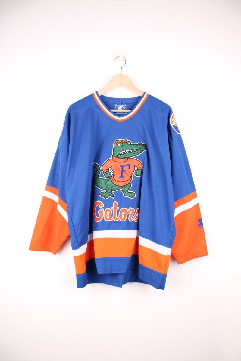 University Of Florida Gators Hockey Jersey in a blue, white and orange colourway, and has the logos embroidered on the front and back. 