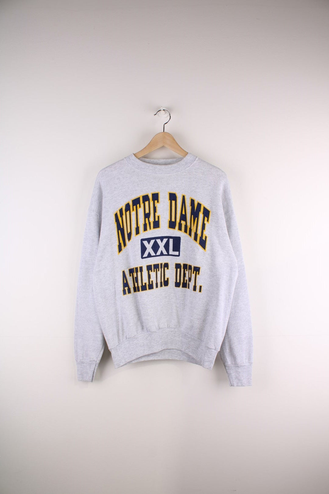 Vintage Notre Dame Athletic Dept. spellout sweatshirt in grey marl with yellow and navy blue text.