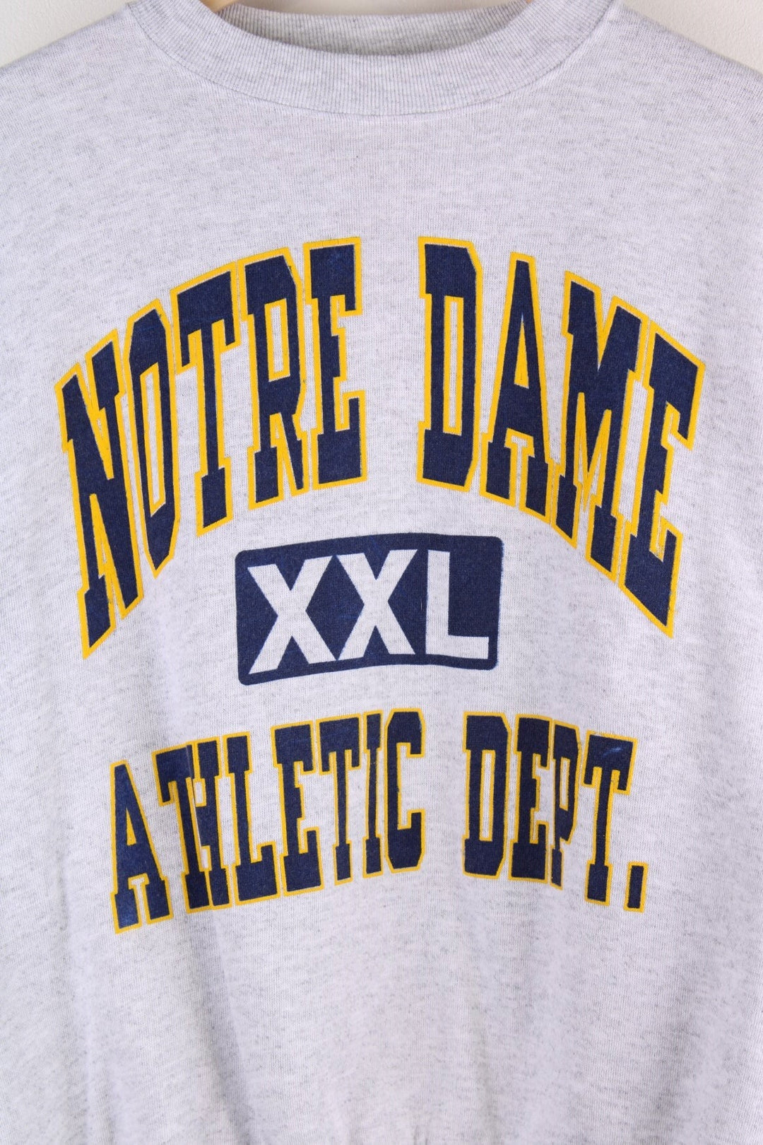 Vintage Notre Dame Athletic Dept. spellout sweatshirt in grey marl with yellow and navy blue text.