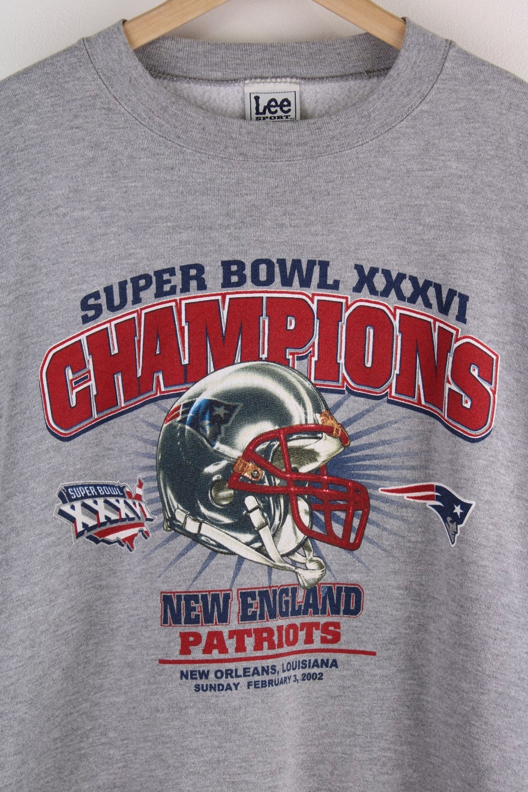 Lee Sport 'New England Patriots 2001 Champions' spellout sweatshirt in grey marl with red and black text and a football helmet graphic on the front.