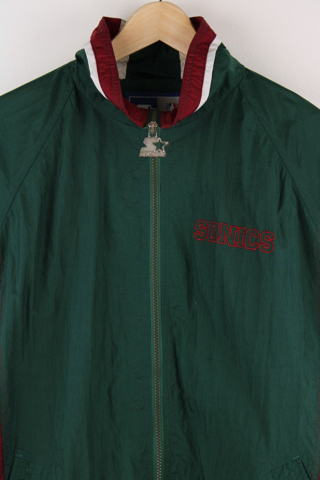 Seattle SuperSonics NFL Starter jacket in green with burgundy and white panels, two pockets, an embroidered team logo on the back and NBA logo on the sleeve.