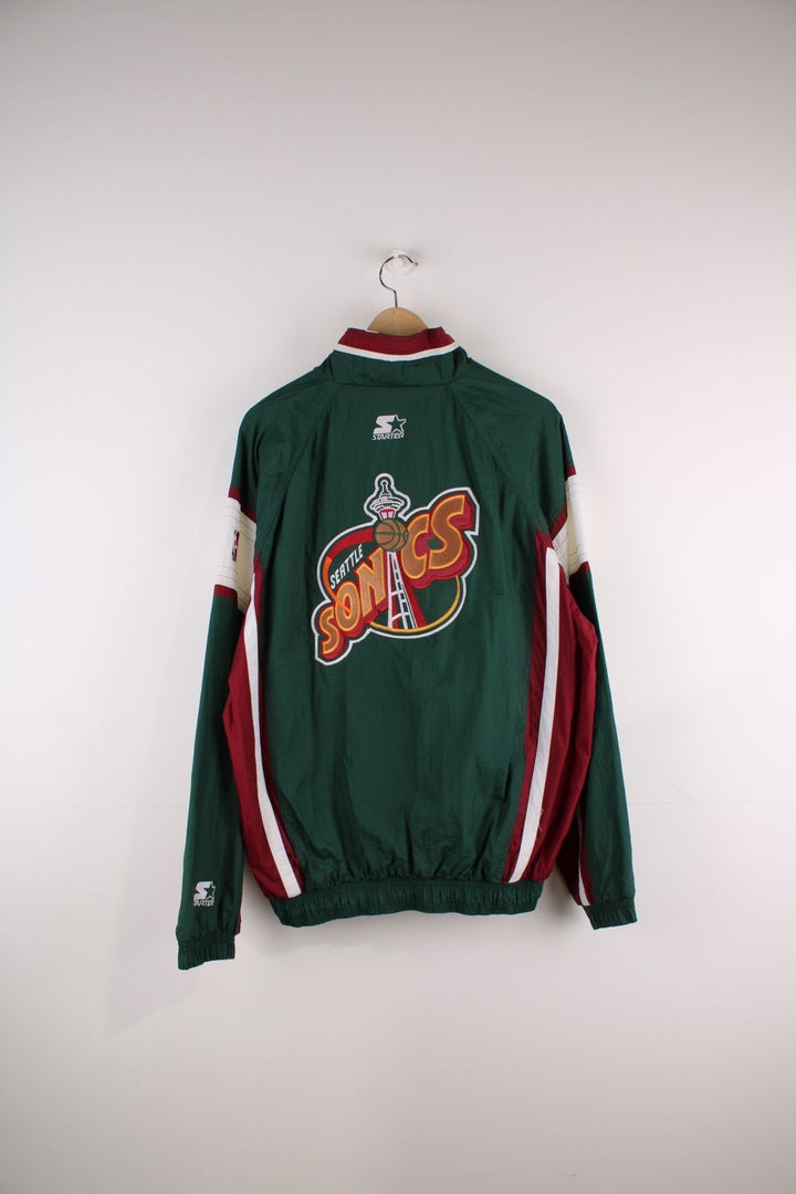 Seattle SuperSonics NLF jacket in  with burgundy and white panels, two pockets, an embroidered team logo on the back and NBA logo on the sleeve.