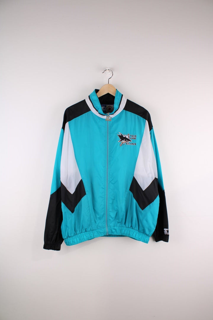 San Jose Sharks Starter Jacket in blue with black and white panels and the team logo embroidered on the chest and back.