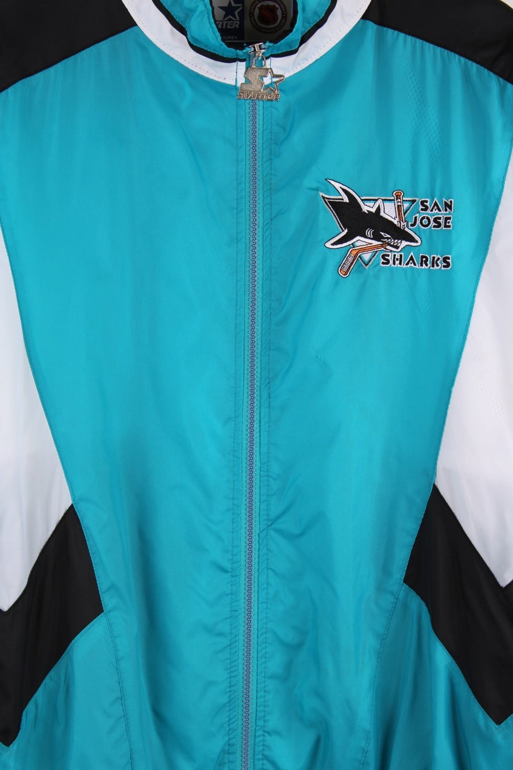 San Jose Sharks Starter Jacket in blue with black and white panels and the team logo embroidered on the chest and back.