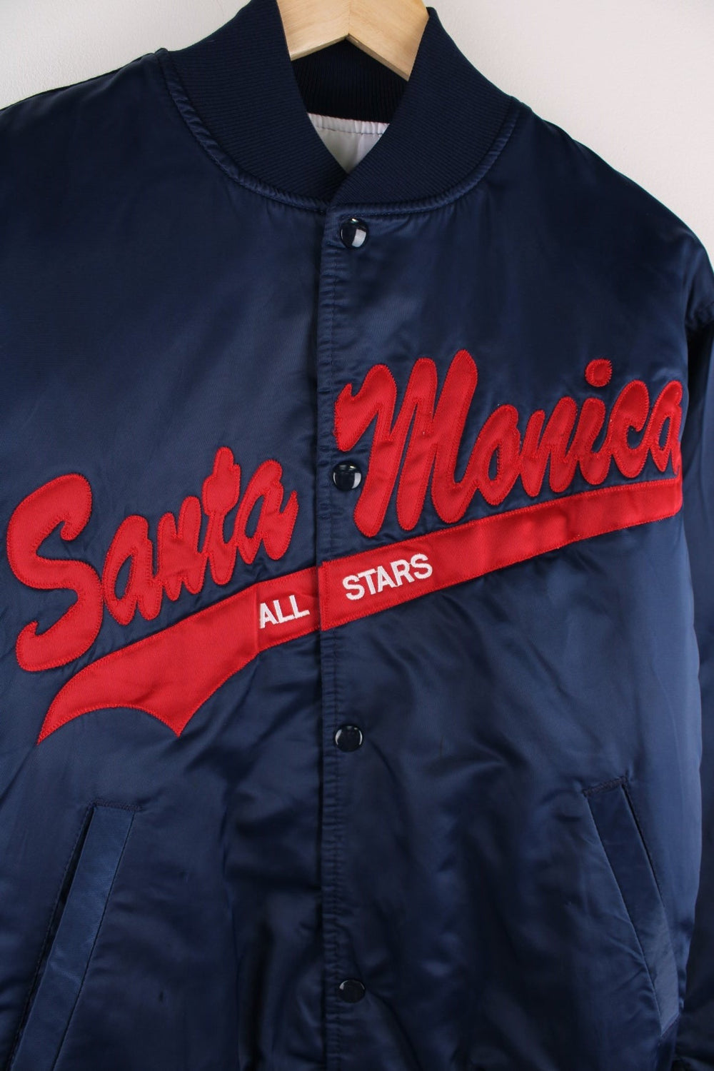 Vintage Santa Monica All Stars bomber jacket in  navy blue with red script embroidery on the front and 'Rosenblum' over a red star on the back.