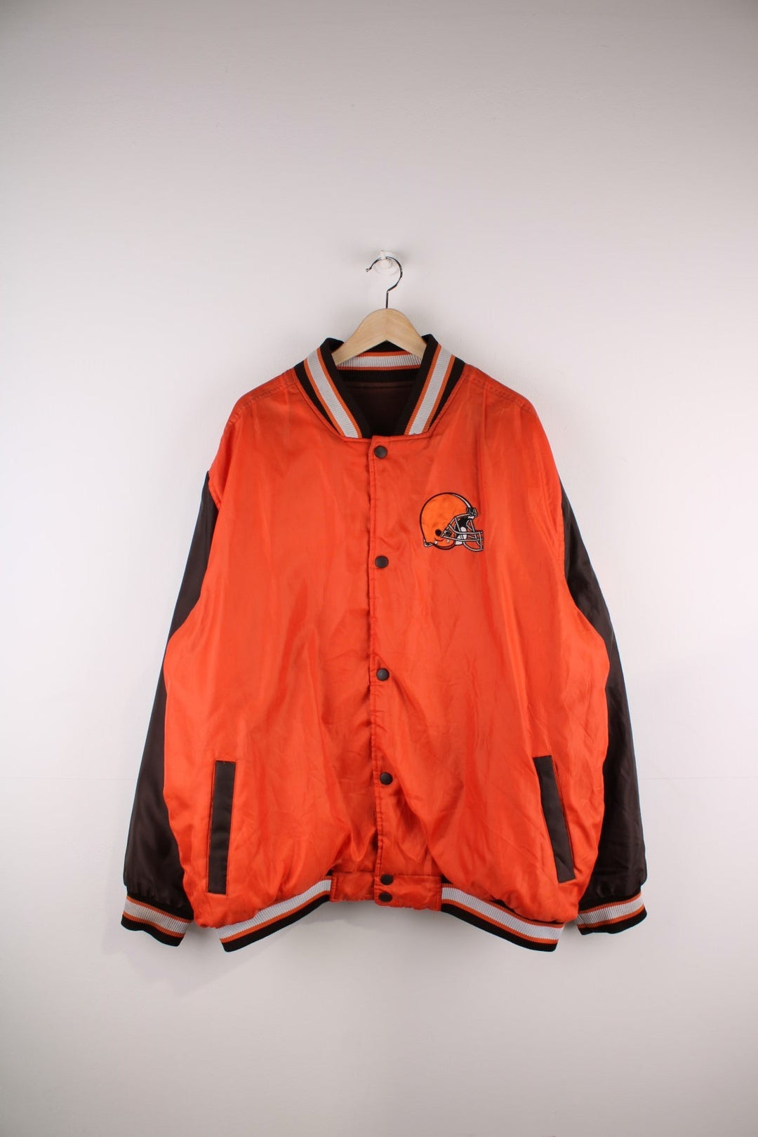 Cleveland Browns Reversible NFL varsity jacket in brown with orange sleeves and vice versa on the reverse side, with team logos and spellouts on the chest, back and sleeves of both sides.