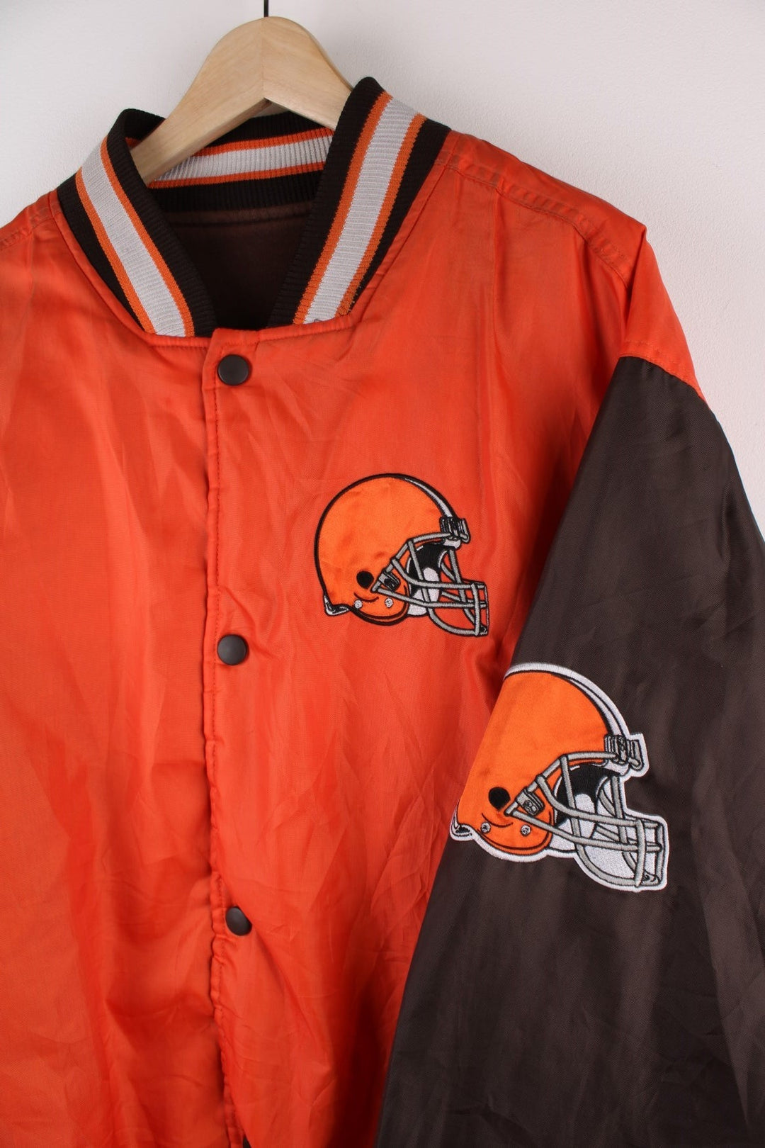 Cleveland Browns Reversible NFL varsity jacket in brown with orange sleeves and vice versa on the reverse side, with team logos and spellouts on the chest, back and sleeves of both sides.