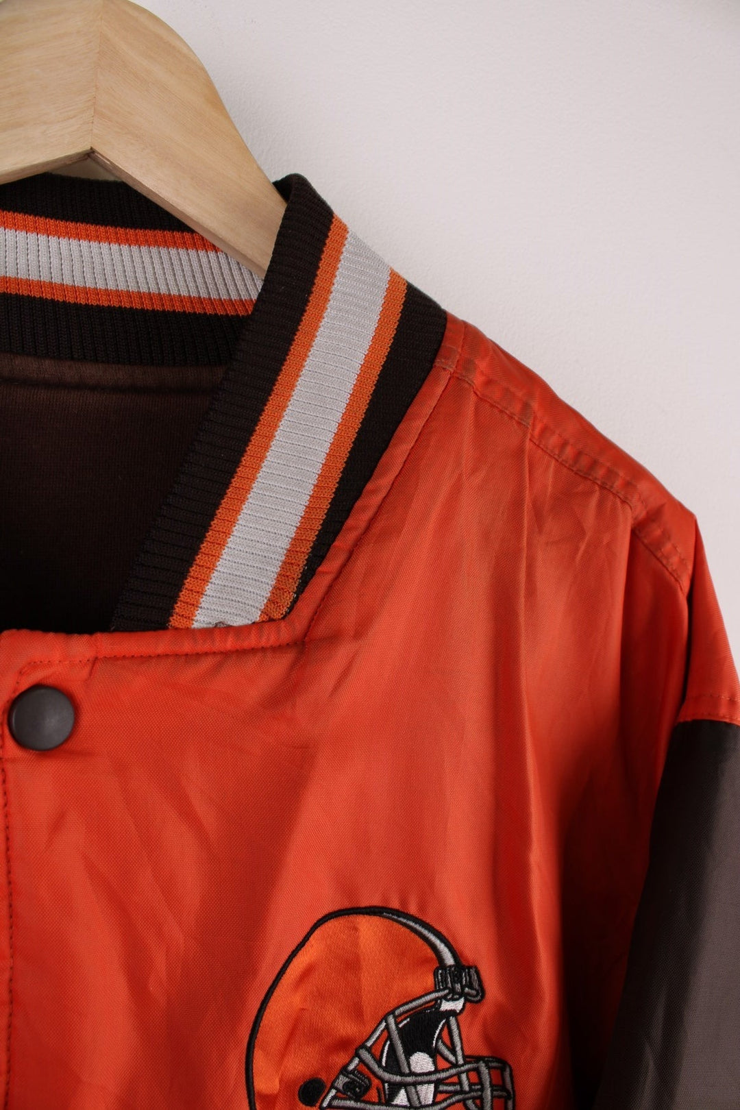 Cleveland Browns Reversible NFL varsity jacket in brown with orange sleeves and vice versa on the reverse side, with team logos and spellouts on the chest, back and sleeves of both sides.