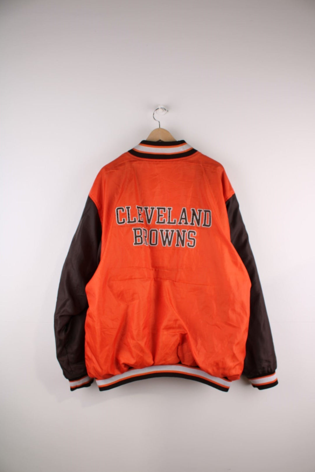 Cleveland Browns Reversible NFL varsity jacket in brown with orange sleeves and vice versa on the reverse side, with team logos and spellouts on the chest, back and sleeves of both sides.