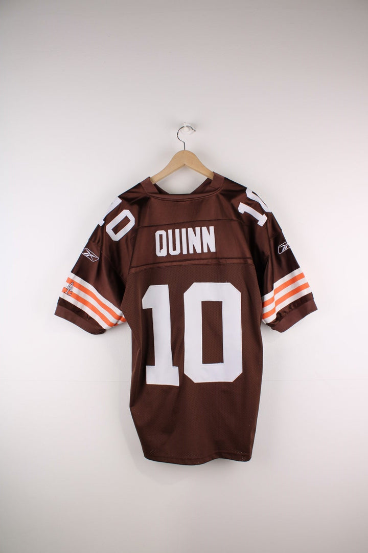 Cleveland Browns #10 Quinn Adidas jersey in brown with orange and white stripe detailing and number 10s embroidered in white on the front, sleeves, and back.