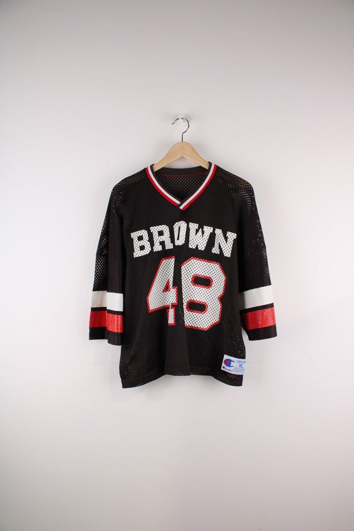 Champion Brown University #48 jersey in brown with red and white stripe detailing and an embroidered Champion patch on the hem.