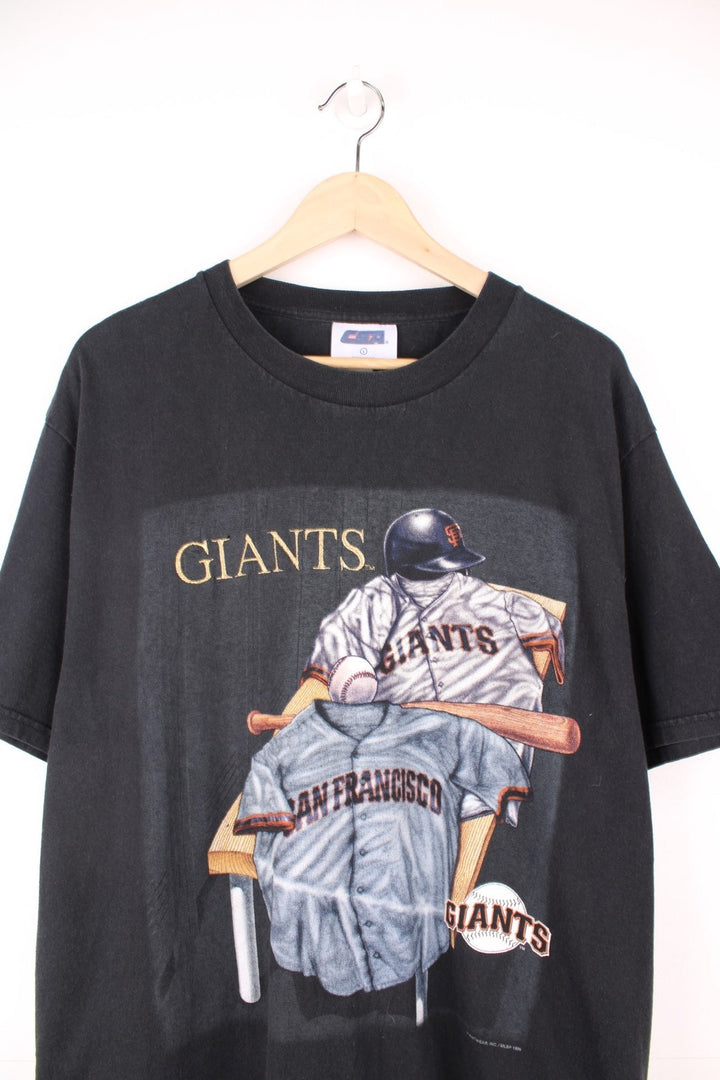 1999 San Francisco Giants MLB T-Shirt in a black colourway with the team spell out embroidered on the front alongside the kit and logo printed. 