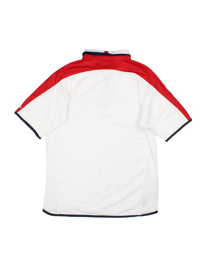 England 2003/05 Umbro home kit reversible football shirt in white with blue stripes and navy blue collar and piping on one side, red on the other. 2 snap closure at the neck, and a logo and badge on the front on both sides.