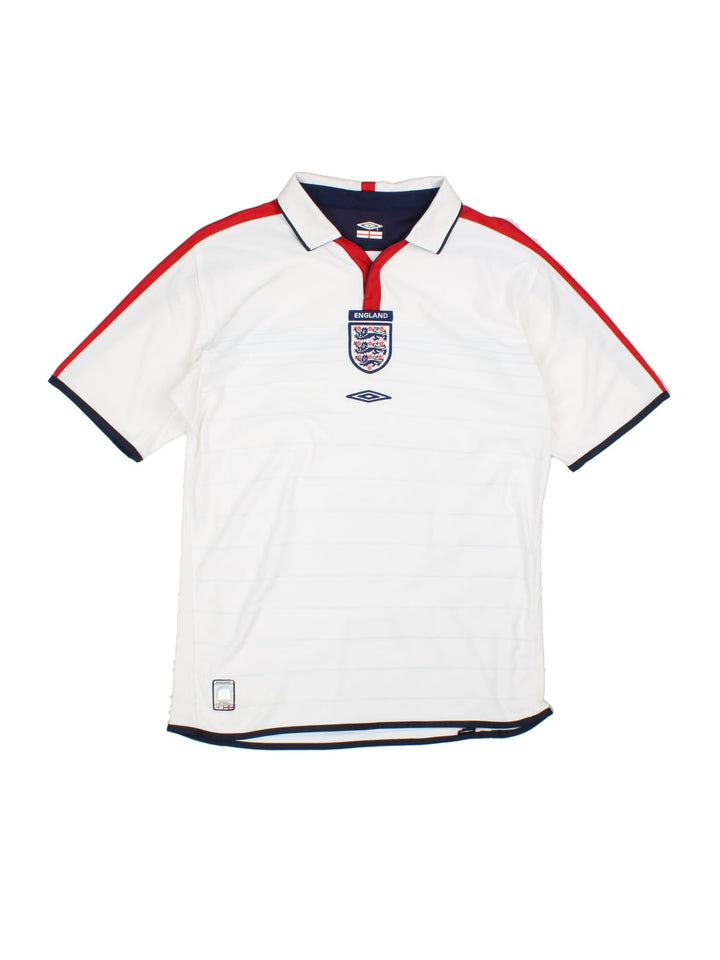 England 2003/05 Umbro home kit reversible football shirt in white with blue stripes and navy blue collar and piping on one side, red on the other. 2 snap closure at the neck, and a logo and badge on the front on both sides.