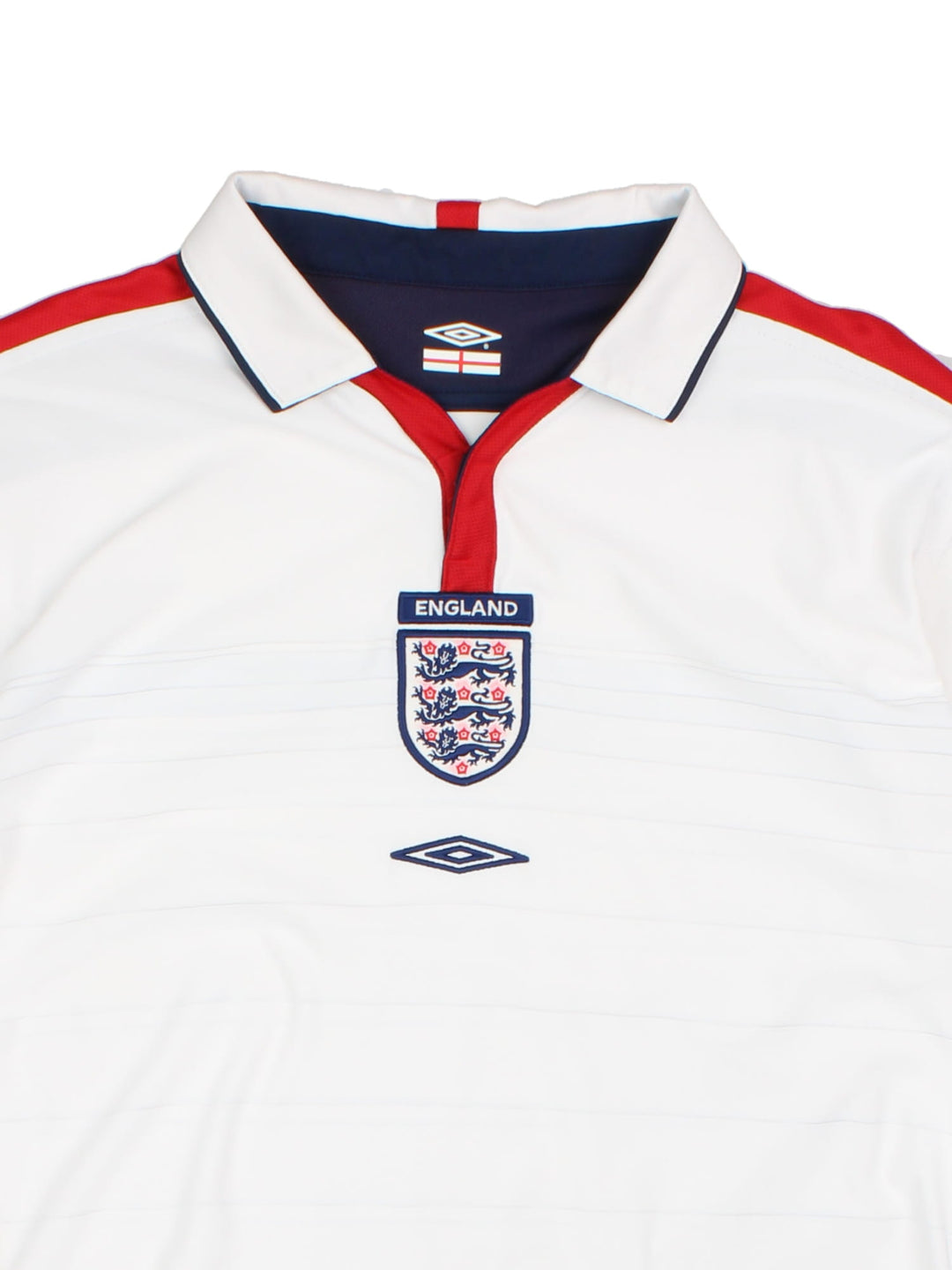 England 2003/05 Umbro home kit reversible football shirt in white with blue stripes and navy blue collar and piping on one side, red on the other. 2 snap closure at the neck, and a logo and badge on the front on both sides.