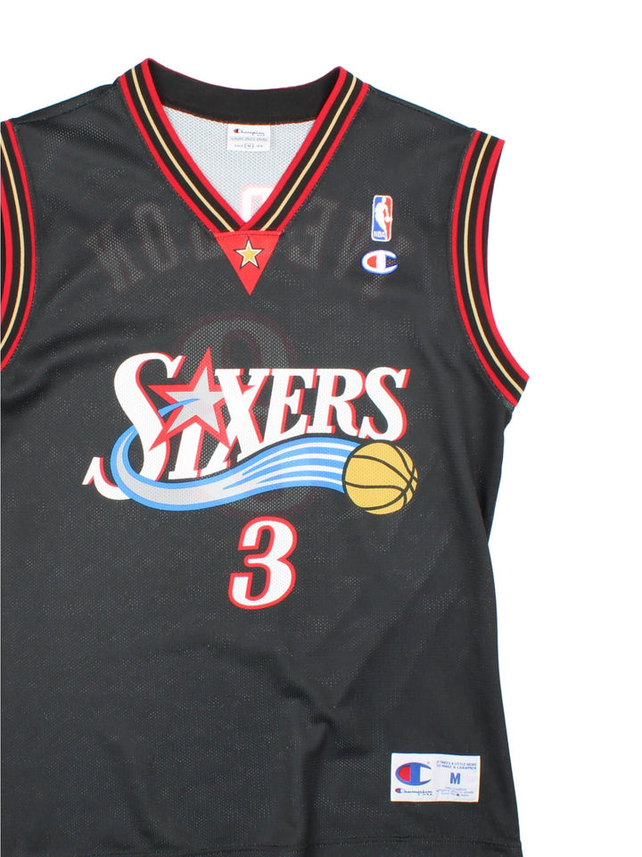 Philadelphia 76ers Champion NBA jersey in black with red and yellow stripe detail, printed and embroidered logos on the front, and no. 3 Iverson on the back.