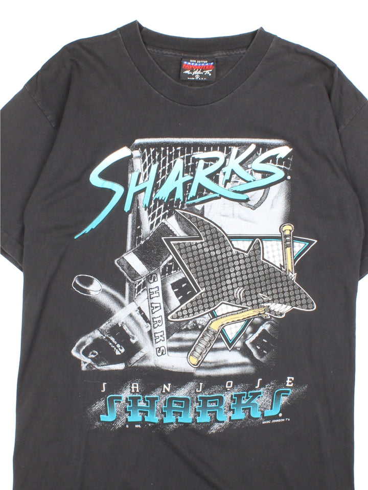 90s San Jose Sharks NHL single stitch t-shirt in black with printed front graphic of a shark and hockey stick.