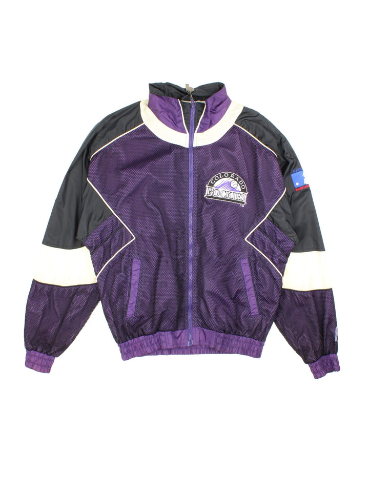 90s Pro Player Colorado Rockies MLB zip-through windbreaker jacket in purple with black and white panelling, two pockets, a branded 'P' zip pull, and embroidered logos on the front, back, and sleeves.