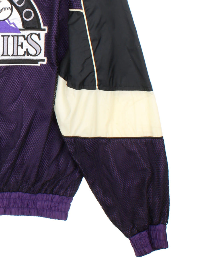 90s Pro Player Colorado Rockies MLB zip-through windbreaker jacket in purple with black and white panelling, two pockets, a branded 'P' zip pull, and embroidered logos on the front, back, and sleeves.