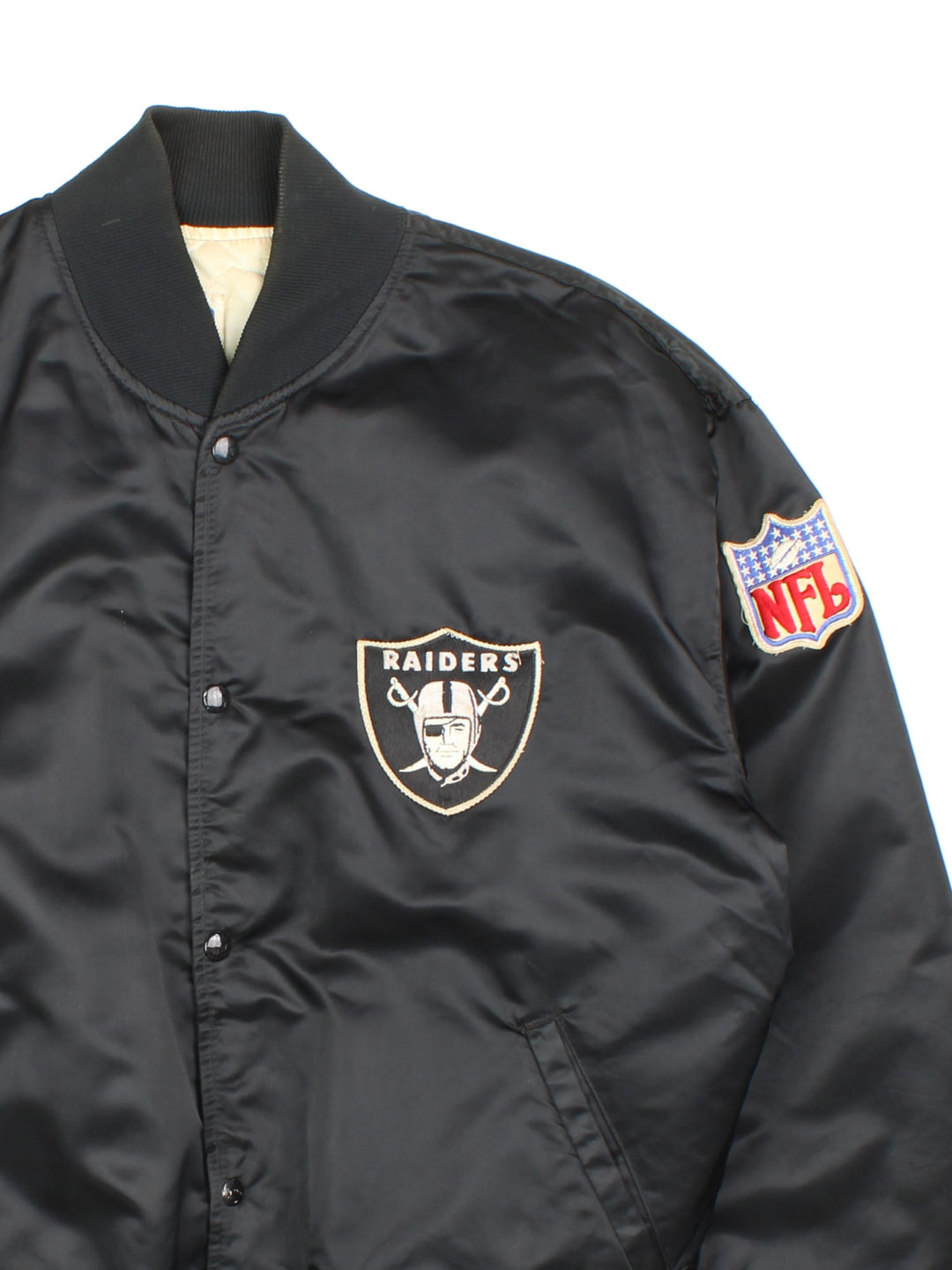 80s Los Angeles Raiders NFL Starter jacket in black with snap closure, two pockets, and embroidered team and NFL logos on the front, back, and sleeve.