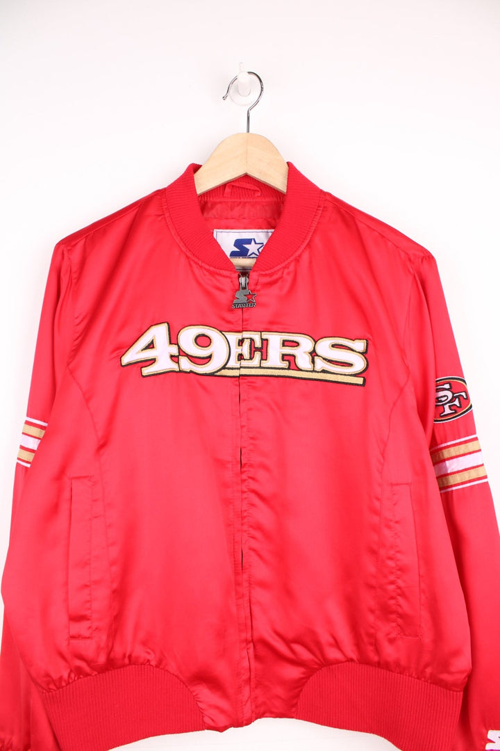 San Francisco 49ers satin zip through bomber jacket with embroidered logo across the chest.