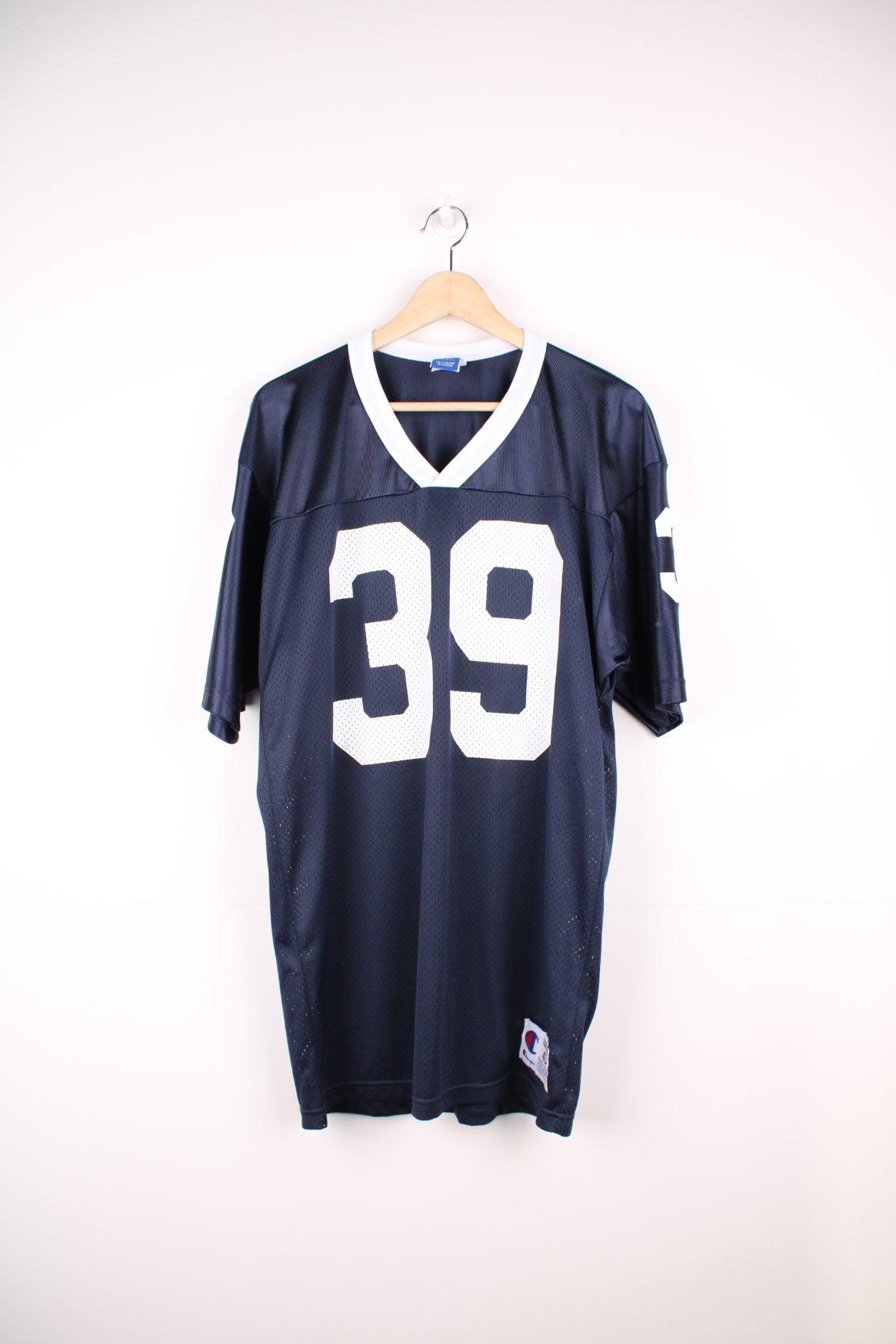 Champion American Football Jersey in a blue and white colourway, number 39 printed on the front and back, and has the logo embroidered on the sleeves. 