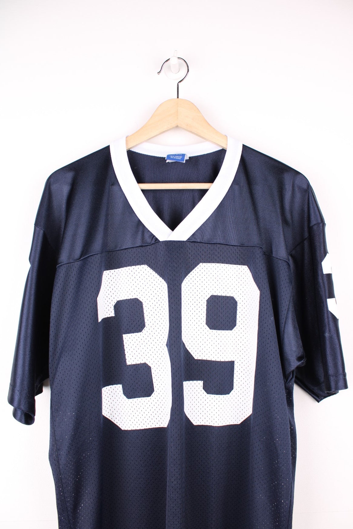 Champion American Football Jersey in a blue and white colourway, number 39 printed on the front and back, and has the logo embroidered on the sleeves. 