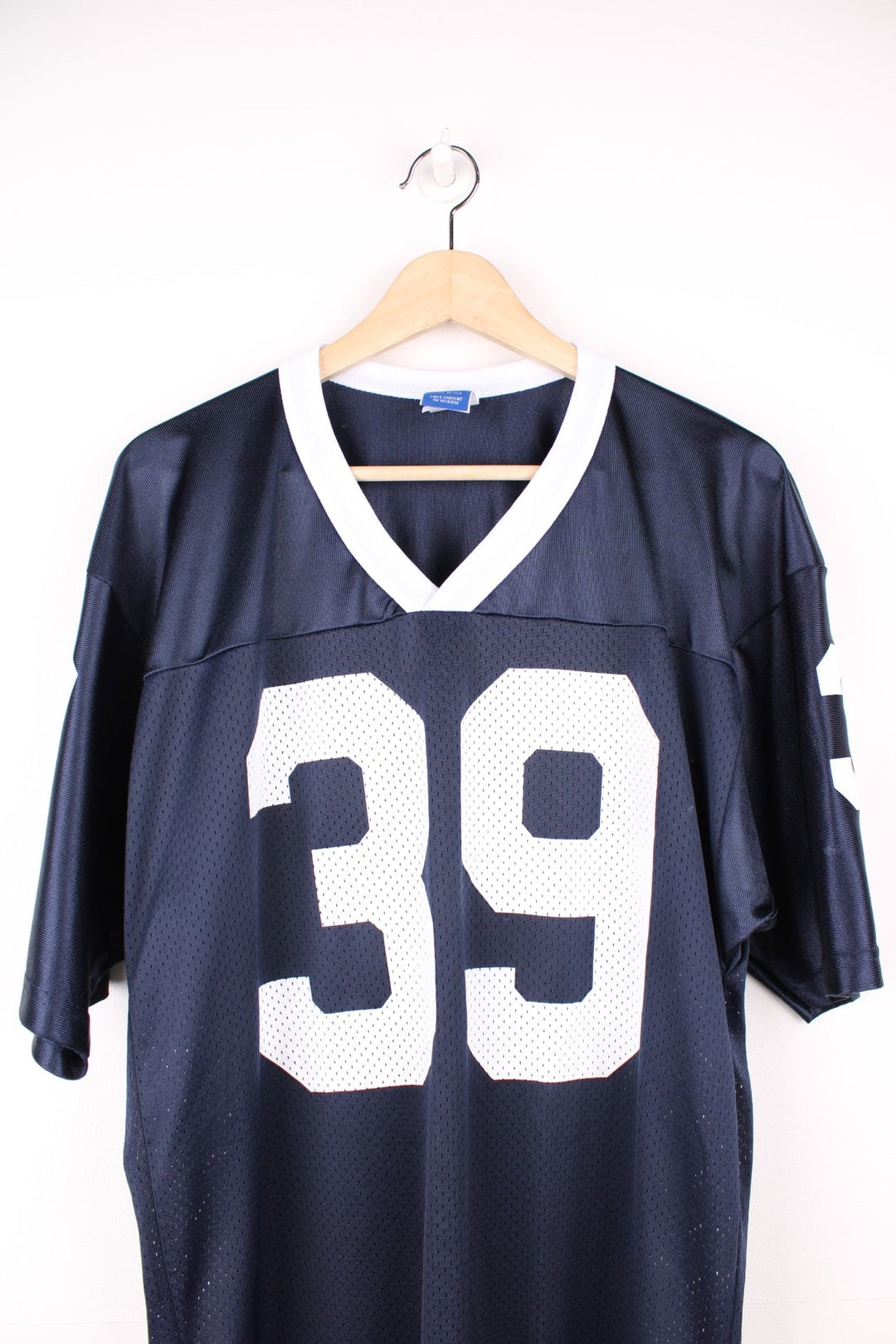 Champion American Football Jersey in a blue and white colourway, number 39 printed on the front and back, and has the logo embroidered on the sleeves. 