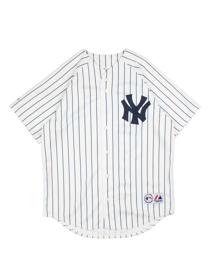 New York Yankees Majestic MLB Jersey in the white home kit colourway, features classic logo on front and traditional blue stripe detailing, button down front, has the player name ABREU and number 53 on the back.