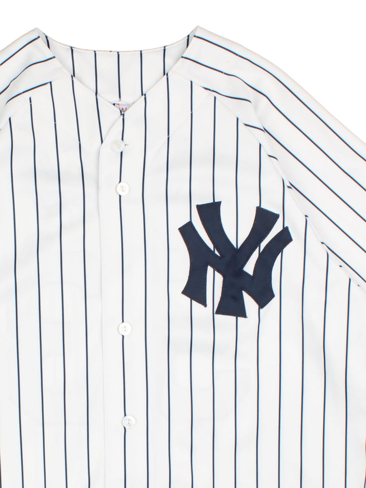 New York Yankees Majestic MLB Jersey in the white home kit colourway, features classic logo on front and traditional blue stripe detailing, button down front, has the player name ABREU and number 53 on the back.