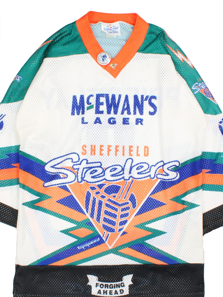 Vintage Sheffield Steelers Ice Hockey Jersey in the white colourway, features large logo and graphic and badge on the front. Two vintage 90's badge pins attached to collar and player name and number on back.