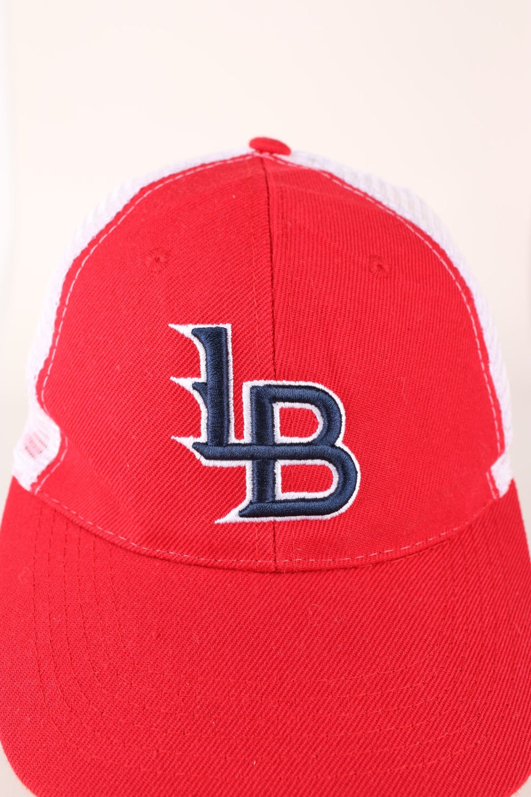 Vintage Louisville Bats Baseball cap in red and white with adjustable strap at the back.