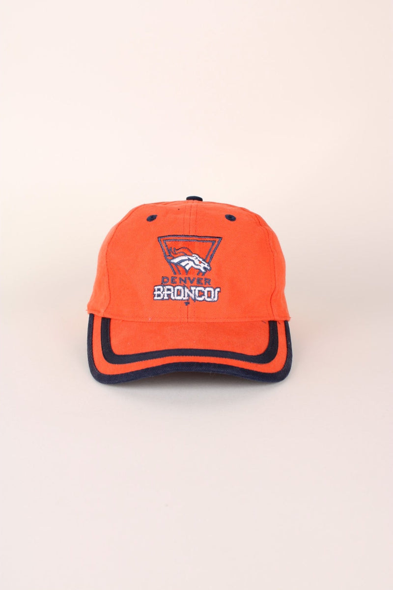 Vintage Denver Broncos Puma cap in orange with embroidered logo and navy blue detailing. Has adjustable strap at the back.