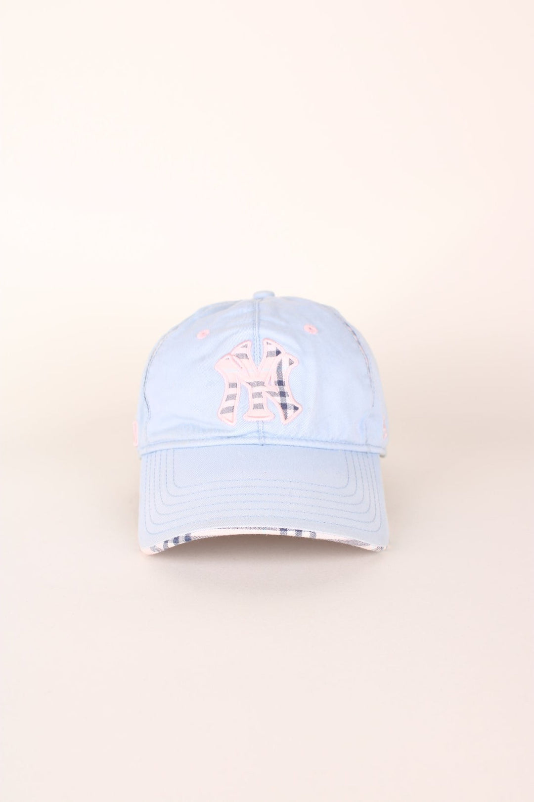 Vintage New York Yankees baseball cap in a blue and pink colourway with signature embroidered logo, check detailing and adjustable strap on the back.  