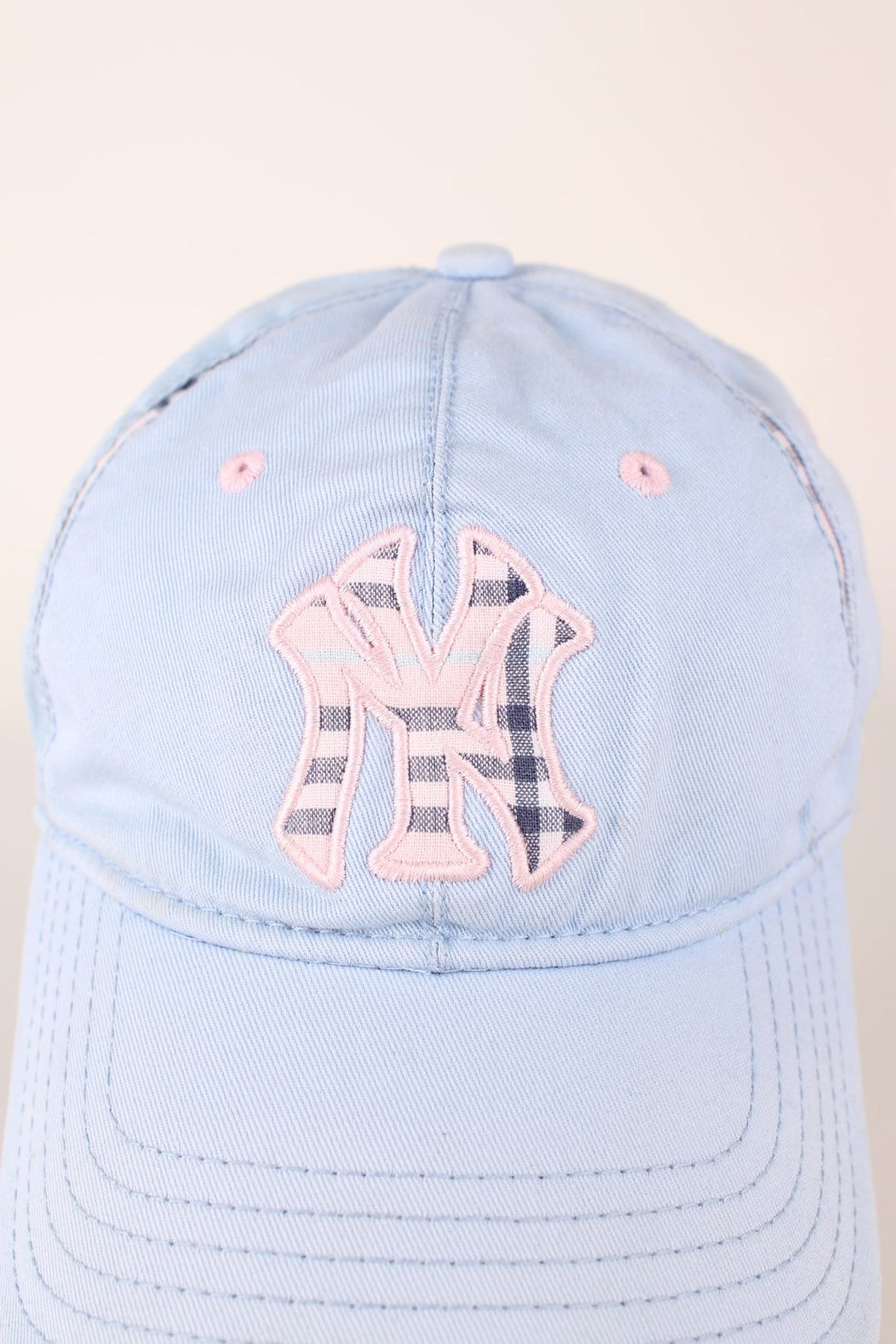 Vintage New York Yankees baseball cap in a blue and pink colourway with signature embroidered logo, check detailing and adjustable strap on the back.  