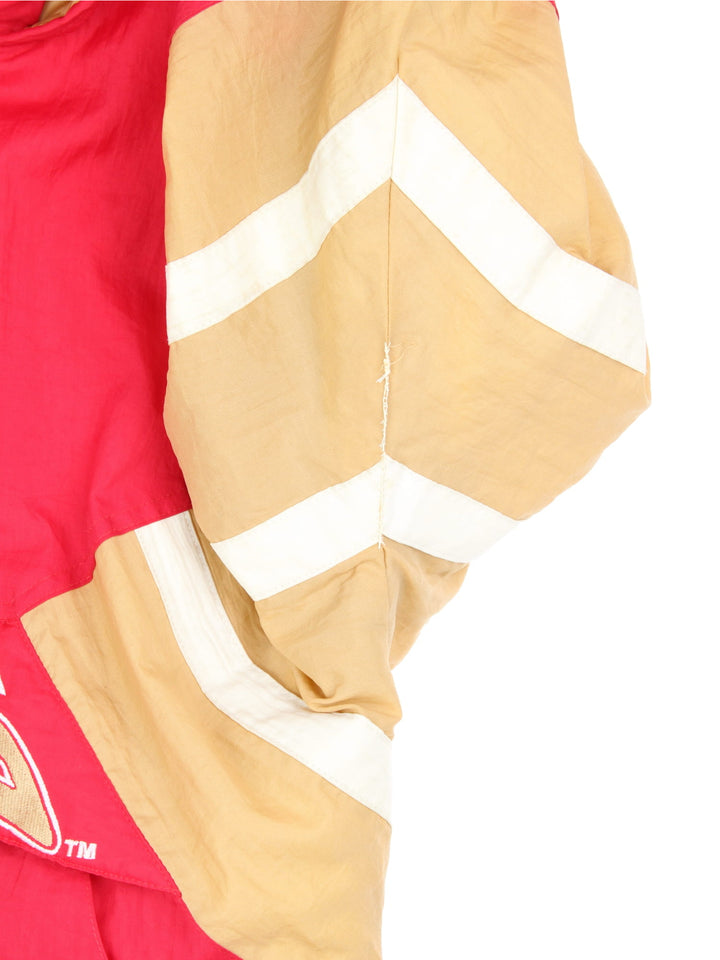 San Francisco 49ers, NFL pro sport jacket in a red colourway with beige and white side panels. Zip closure and hood, with team logos on the front, sleeve and back.