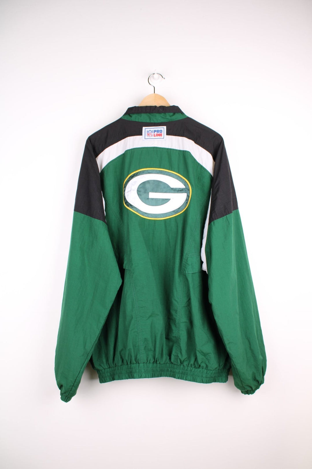 NFL Packers and Reebok pro sport jacket in a green colourway with white and black shoulder panels. Zip closure with team logos on the front and back.