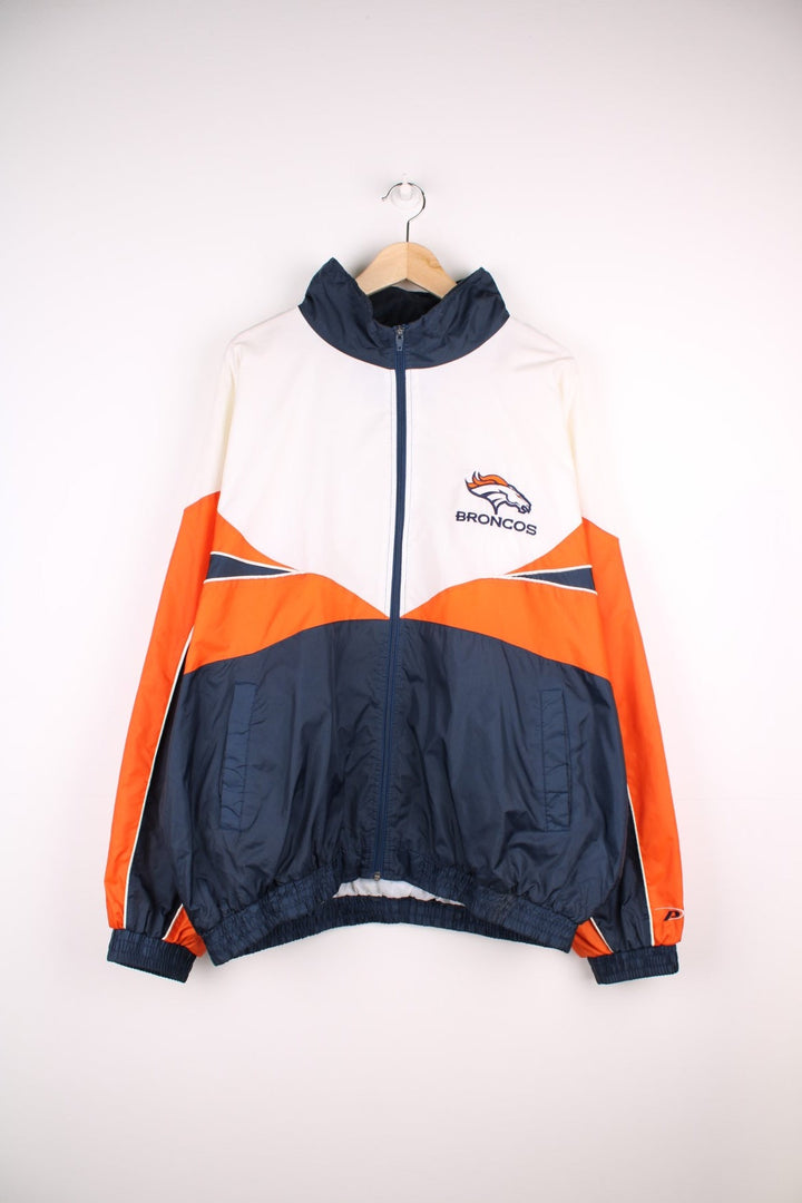 Broncos pro sport jacket in white, orange and navy. Zip closure with team logos embroidered on the front and back.