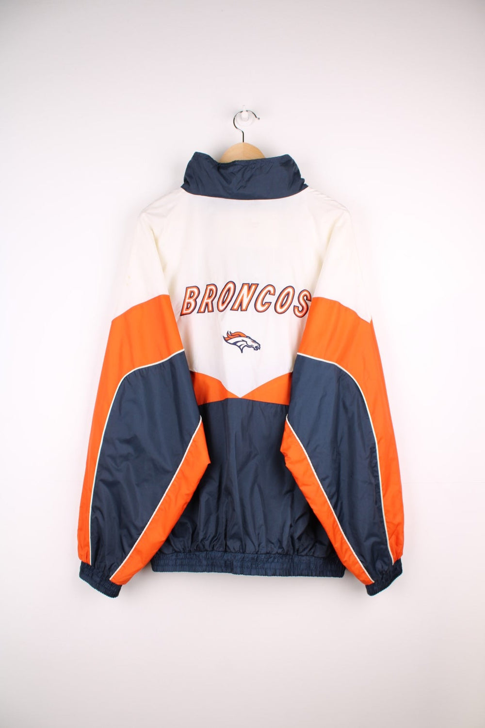 Broncos pro sport jacket in white, orange and navy. Zip closure with team logos embroidered on the front and back.