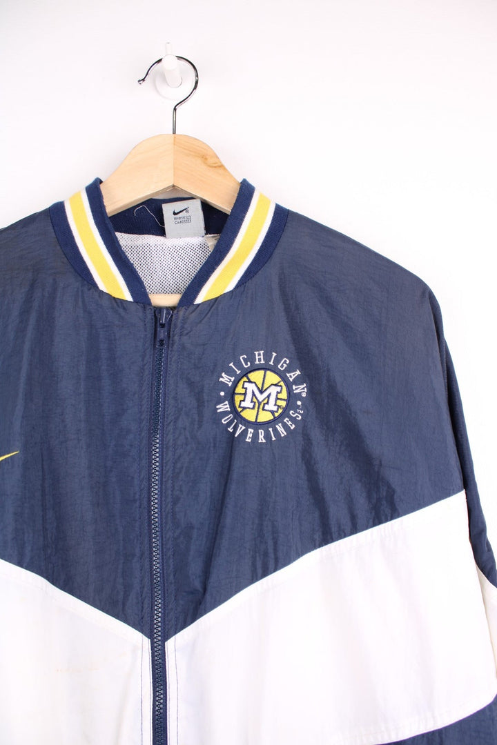 Michican Wolverines pro sport jacket in a navy colourway with white and yellow panels. Zip closure with team logos embroidered on the front and back.