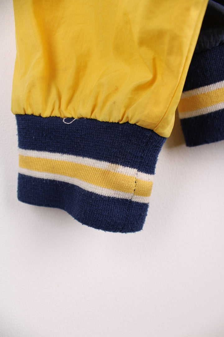 Michican Wolverines pro sport jacket in a navy colourway with white and yellow panels. Zip closure with team logos embroidered on the front and back.