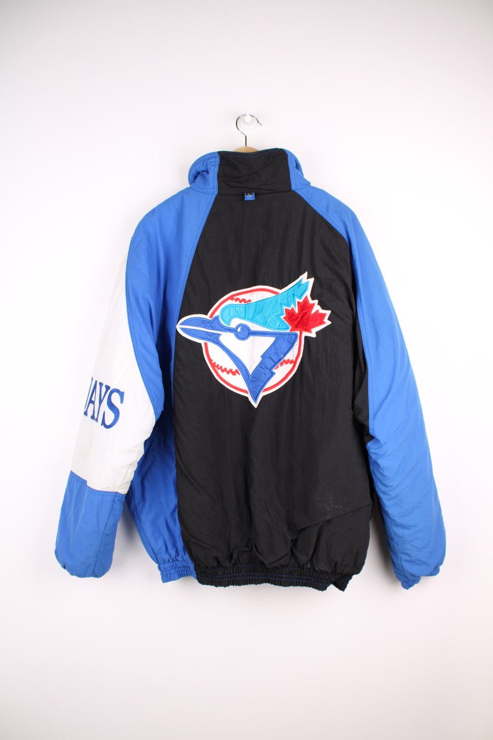 Toronto Blue Jays pro sport jacket in blue black and white. Zip and snap fastener closure with team logos embroidered on the front, back and sleeve.