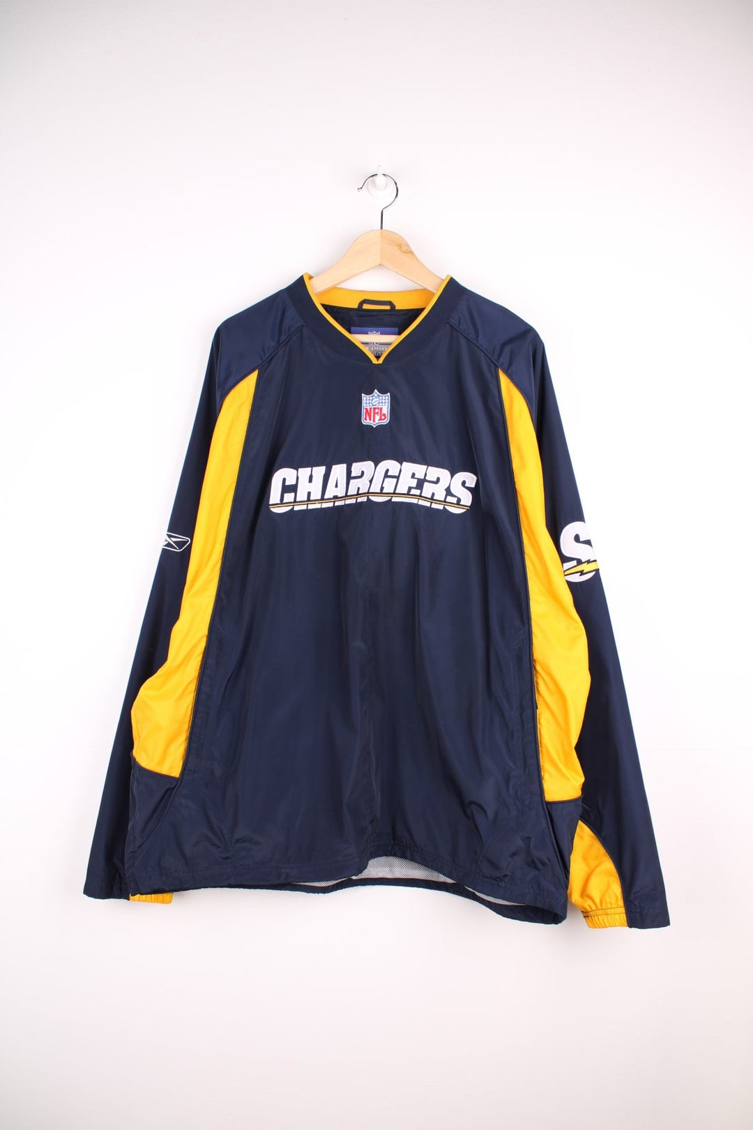 Chargers NFL drill top in a navy colourway with yellow side panels. Chargers logo on front and back and NFL logo on front.