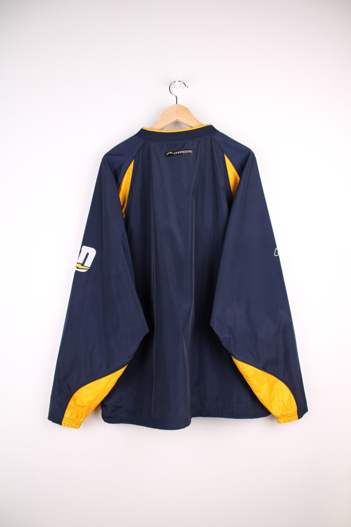 Chargers NFL drill top in a navy colourway with yellow side panels. Chargers logo on front and back and NFL logo on front.