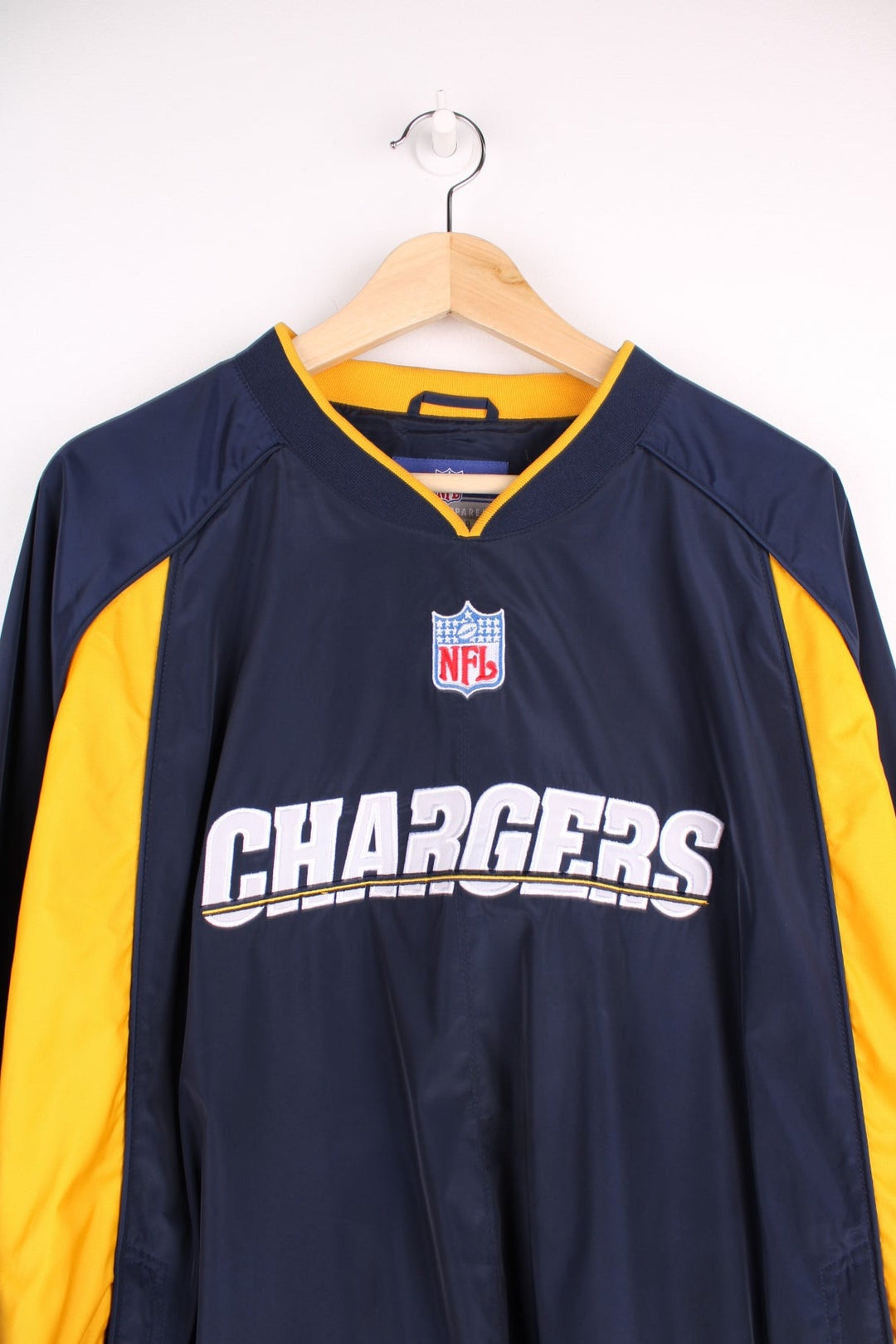 Chargers NFL drill top in a navy colourway with yellow side panels. Chargers logo on front and back and NFL logo on front.